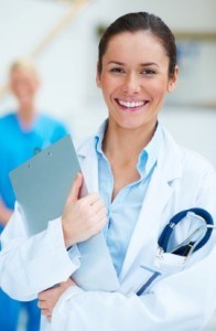 Happy young female medical doctor with stethoscope and clipboard