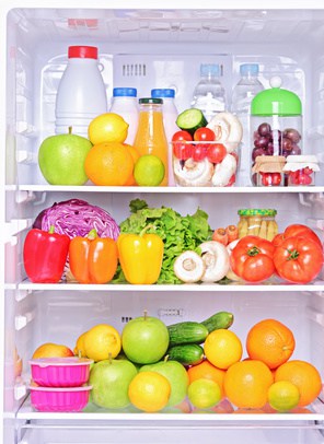 Shot of an open fridge with food products