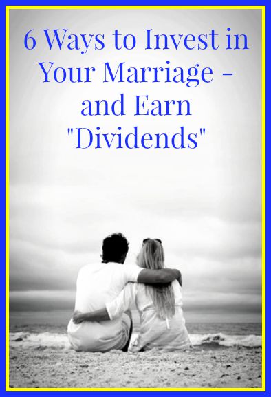A happy young couple is sitting on the white sand beach looking out over the ocean on a cloudy summer morning while on vacation. Vertical area for copy-space.